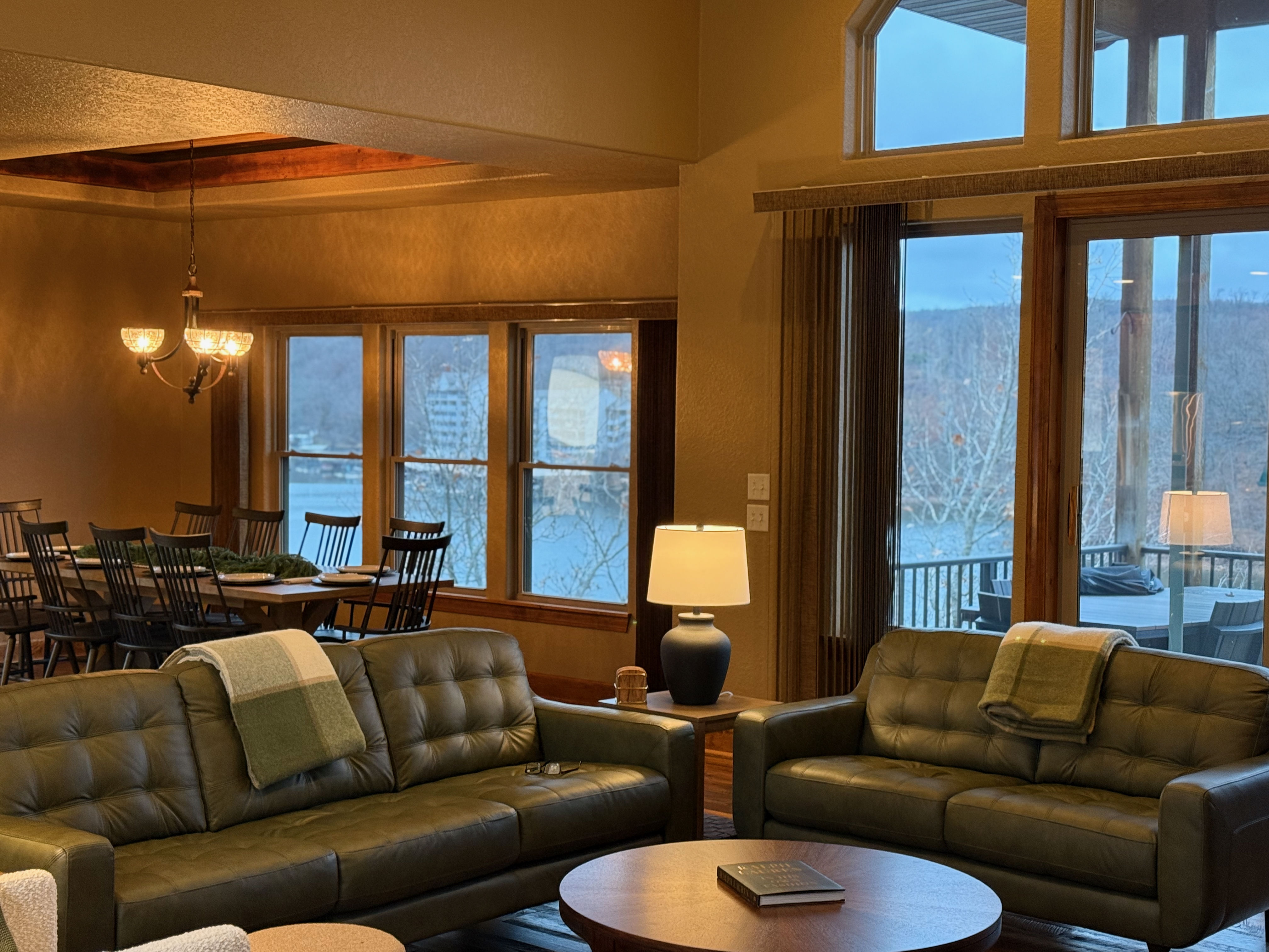Main living room in warm evening lighting with dining area